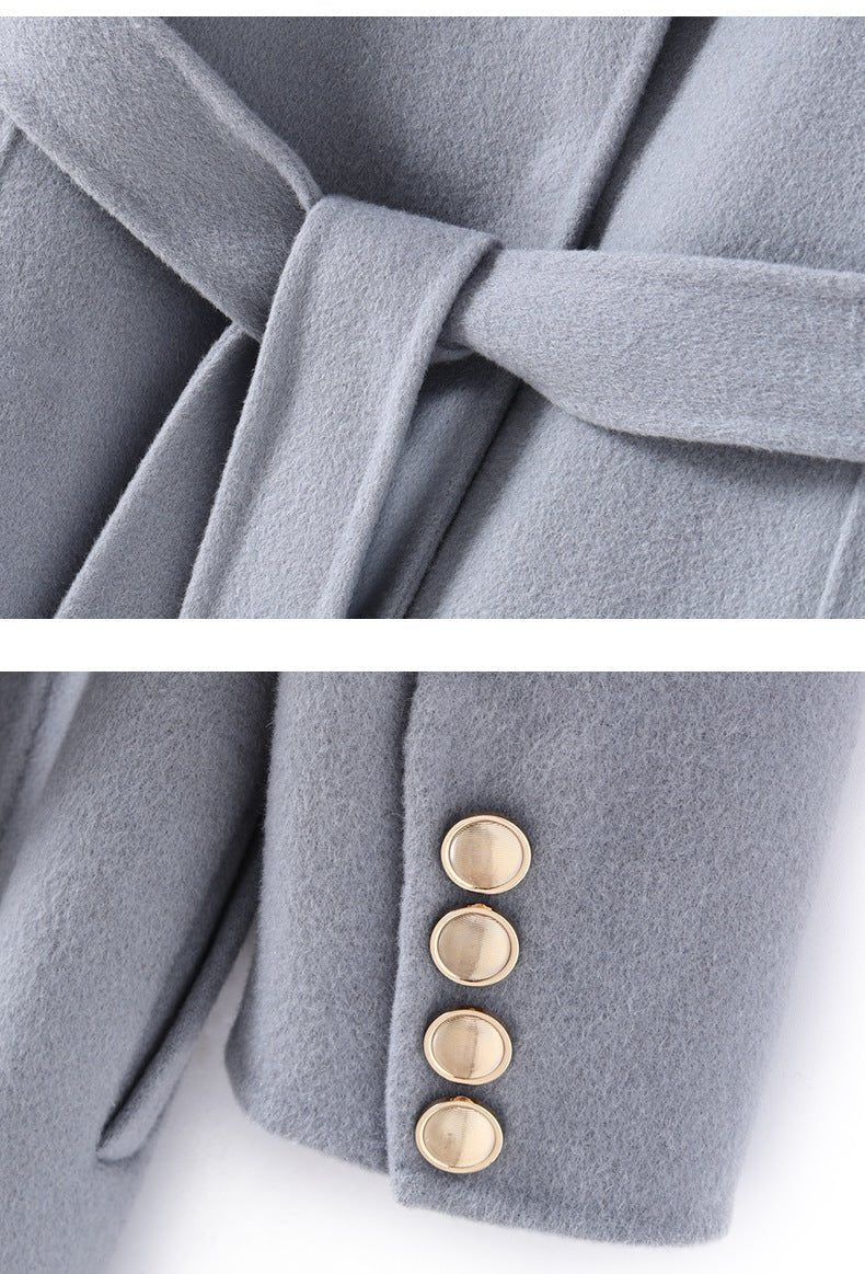 Close-up of Extra-Long Double Wool Coat With Detachable Shawl Collar in soft gray featuring a stylish belt and button details