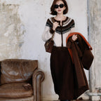 Fashion model wearing a Fair Isle Core Cardigan with elegant style and accessories, set in a vintage backdrop