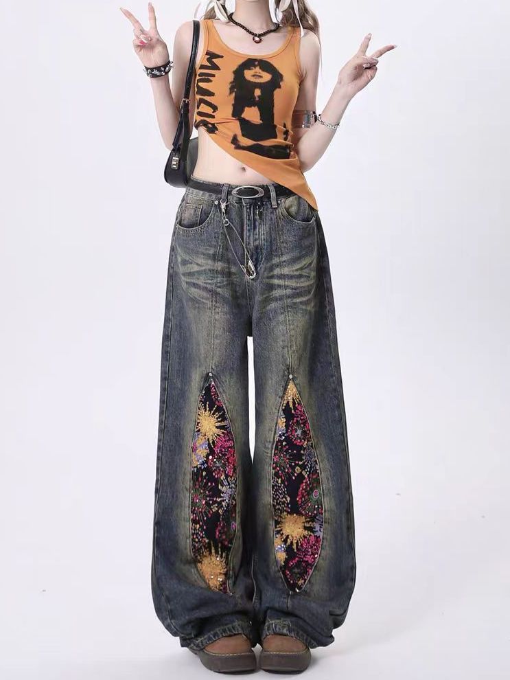 Firework Bloom Wide-Leg Denim Pants featuring colorful floral embellishments on side cutouts