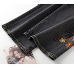 Close-up of Floral Rhinestone Vintage Jeans showcasing intricate floral embroidery on dark denim fabric