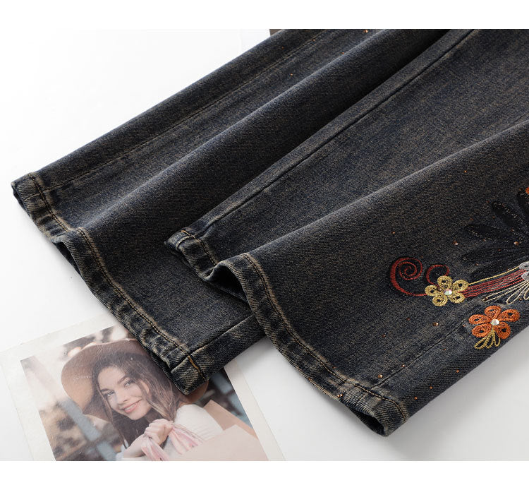 Close-up of Floral Rhinestone Vintage Jeans showcasing intricate floral embroidery on dark denim fabric