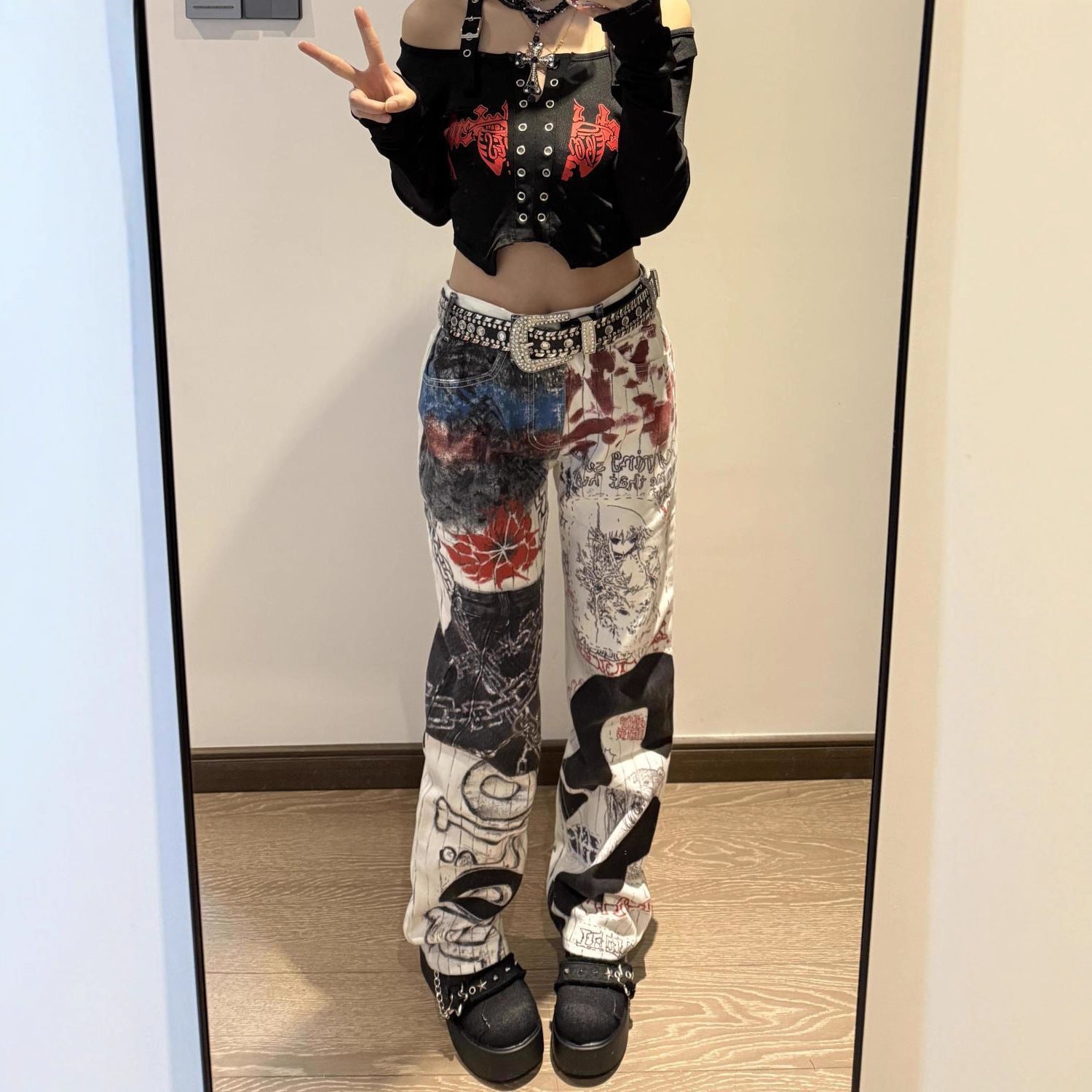 Trendy outfit featuring Graffiti Heat Straight Denim pants with unique artistic designs and a stylish crop top