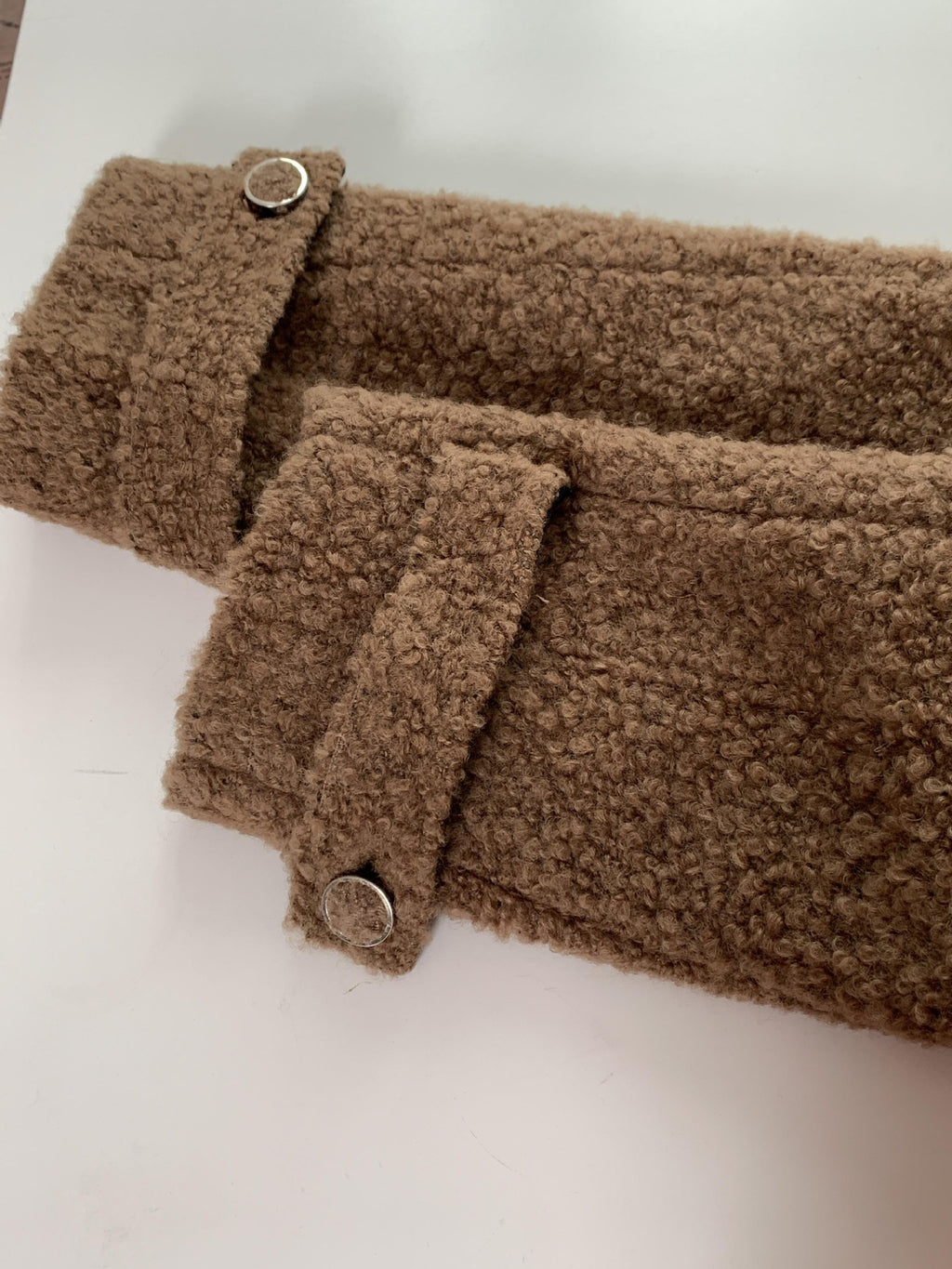 Close-up of sleeves detailing on High-End Loose Fit Wool Winter Coat with button accents