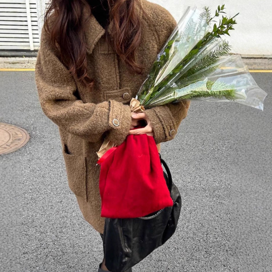 Model wearing a High-End Loose Fit Wool Winter Coat in brown, holding a bouquet and a red bag