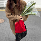 Model wearing a High-End Loose Fit Wool Winter Coat in brown, holding a bouquet and a red bag