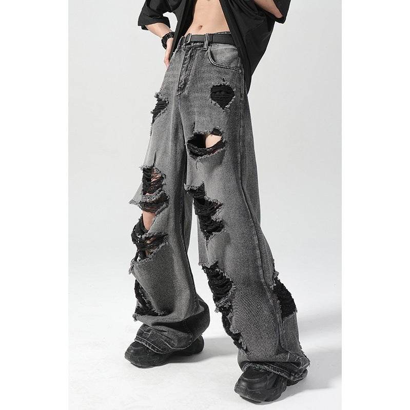 High waisted ripped baggy jeans in faded black denim with multiple large rips and casual street style