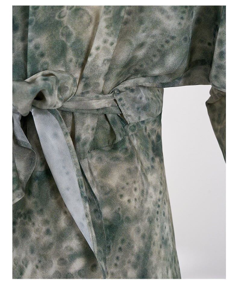 Close-up of Jade Silk Wrap Dress showing fabric texture and waist tie detail