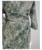 Jade Silk Wrap Dress featuring a unique green pattern and a stylish wrap design for elegant occasions