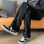 Stylish black jeans with leg studs featuring a relaxed fit, perfect for casual wear