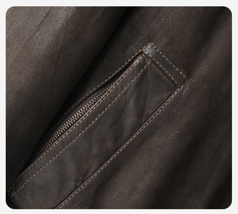 Close-up of Kael Distressed Goatskin Leather Jacket showcasing detailed stitching and zippered pocket