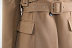 Close-up of a khaki trench coat for women featuring a belted waist and pocket details