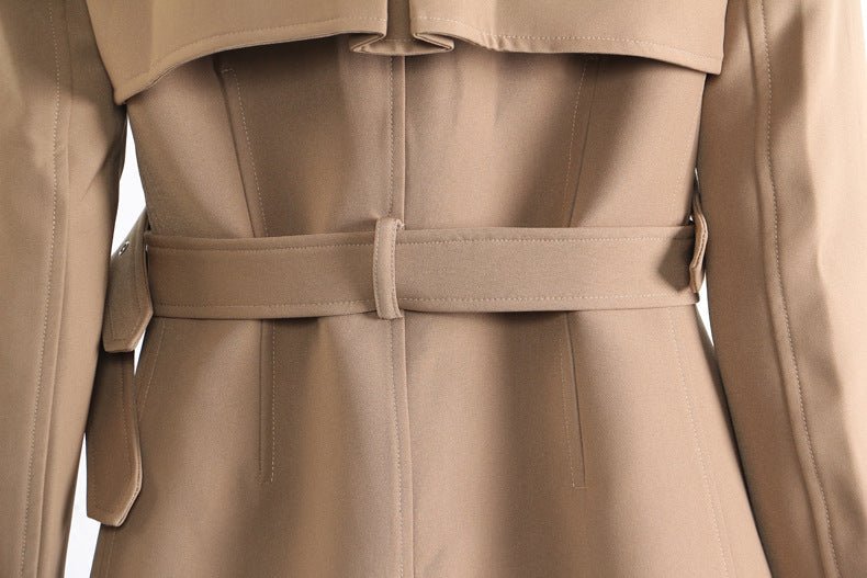 Back view of a stylish khaki trench coat for women featuring a belted waist and elegant design