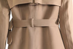 Back view of a stylish khaki trench coat for women featuring a belted waist and elegant design