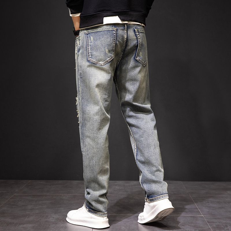 Men's Koi Dynasty Embroidered Jeans in faded blue with a relaxed fit and unique design details