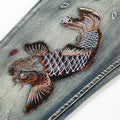 Close-up of Koi Dynasty Embroidered Jeans featuring vibrant koi fish design and intricate detailing