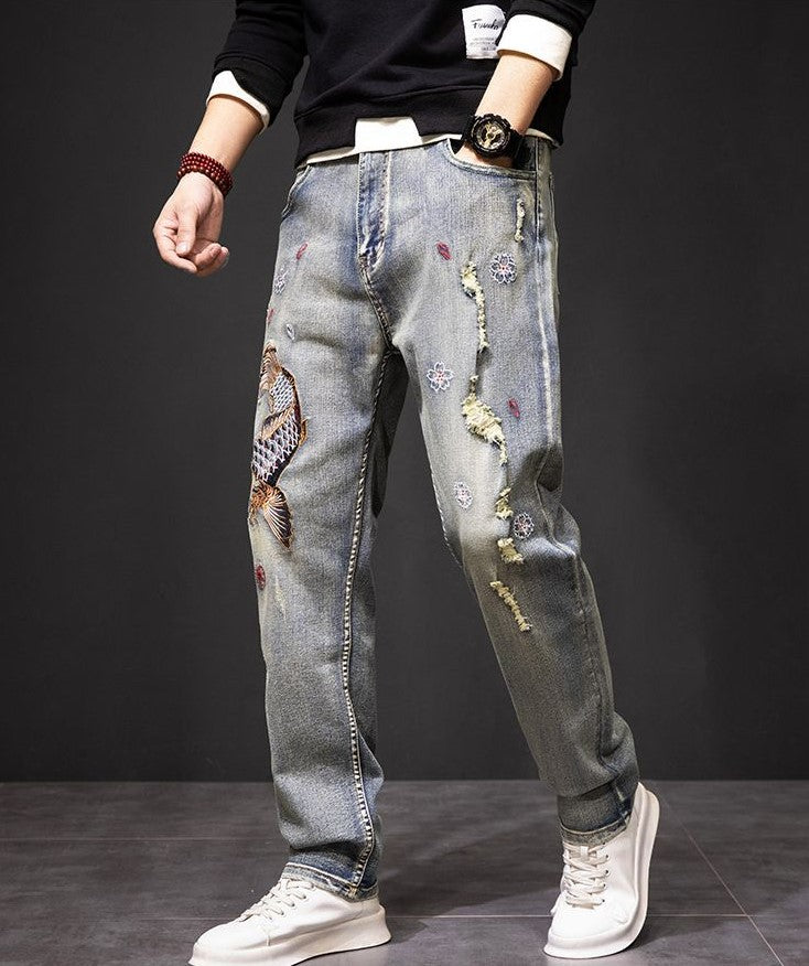 Koi Dynasty Embroidered Jeans featuring unique fish designs and floral embellishments for a stylish look