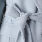 Close-up of a Long Baby Blue Wool Coat featuring a stylish tie belt for a chic look