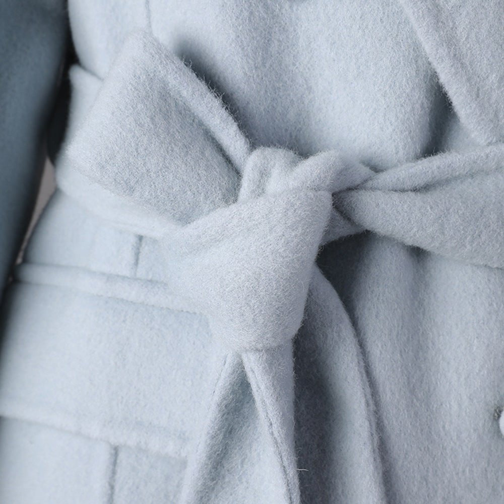 Close-up of a Long Baby Blue Wool Coat featuring a stylish tie belt for a chic look