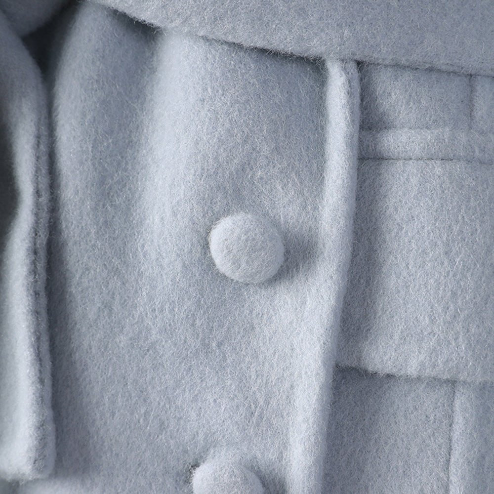 Detail of a soft Long Baby Blue Wool Coat featuring textured fabric and decorative buttons