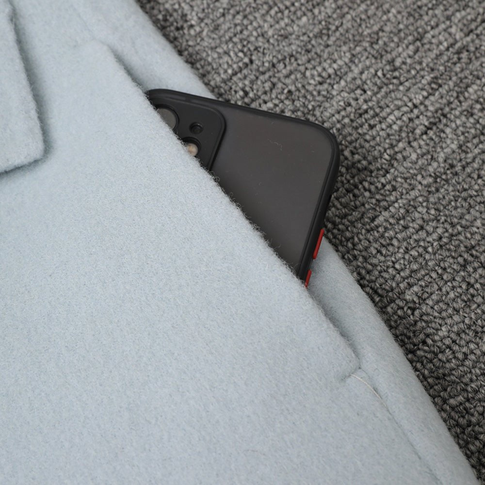 Close-up of Long Baby Blue Wool Coat pocket with a smartphone tucked inside for convenience