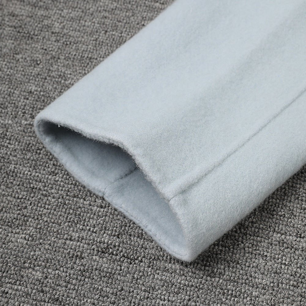 Detail of a Long Baby Blue Wool Coat sleeve showcasing soft fabric and clean stitching