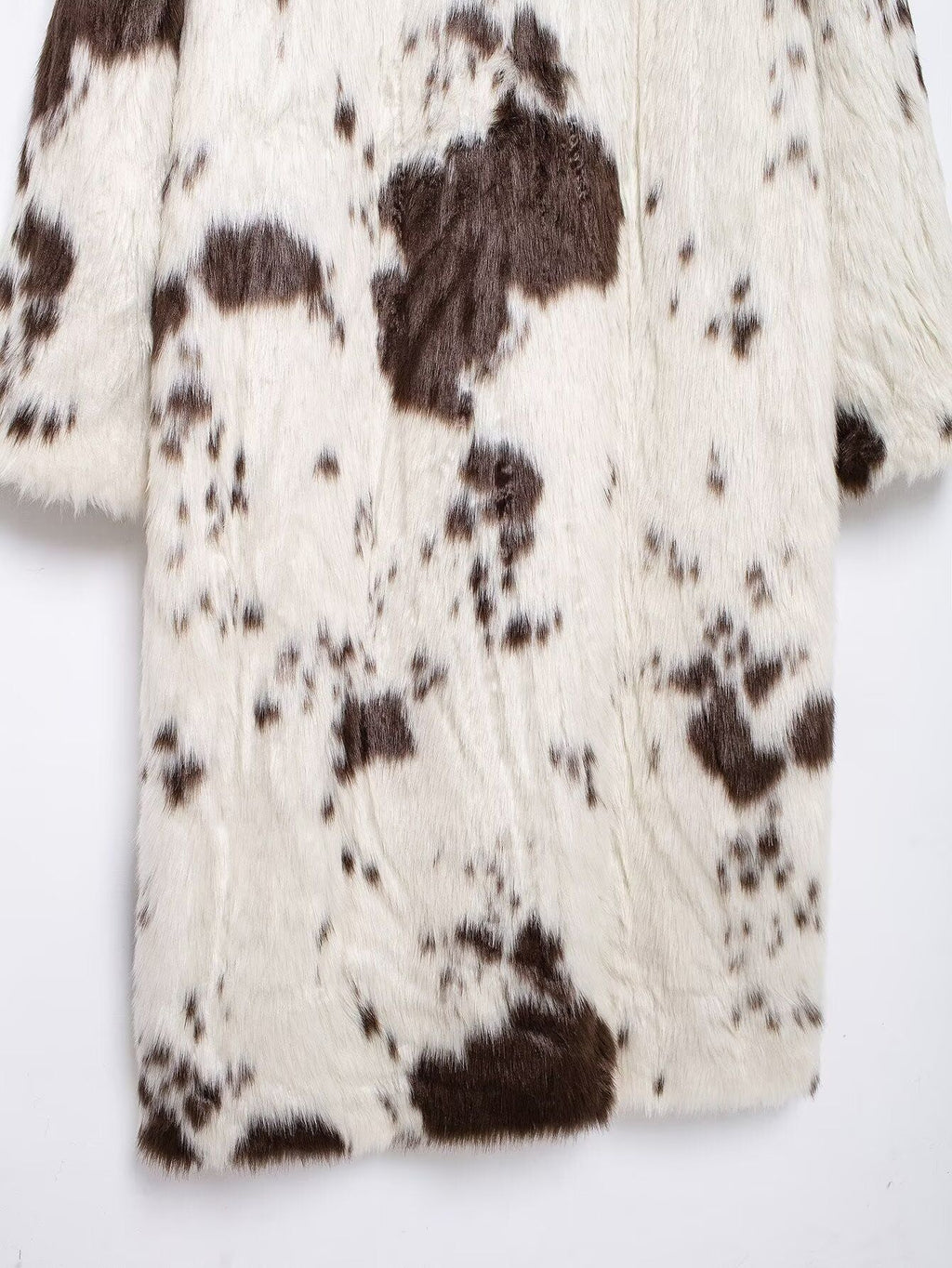 Long Faux Fur Effect Coat in white with brown spots, perfect for stylish winter layering