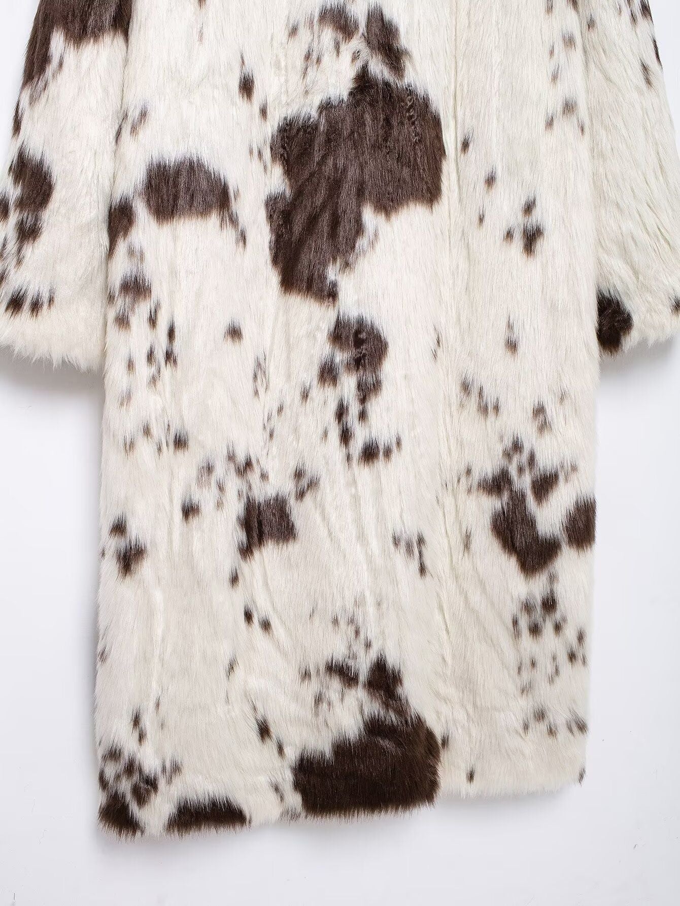 Long Faux Fur Effect Coat in white with brown spots, perfect for stylish winter layering