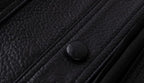 Close-up of a luxury streetwear leather jacket featuring a textured black finish and snap buttons