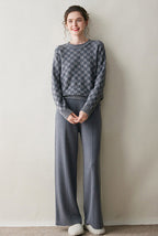 AM Vision RO Luxury women's knit sweater in gray checkered pattern, paired with wide-leg pants