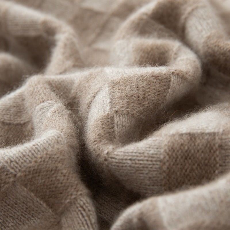 Soft beige fabric close-up of a luxury women's knit sweater showcasing its cozy texture