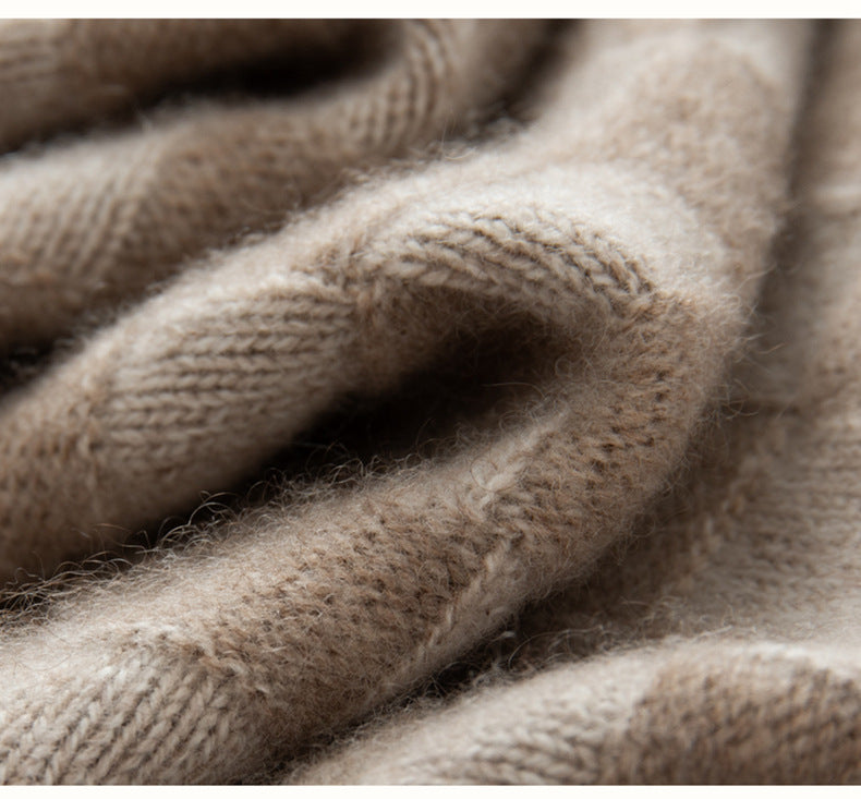 Close-up of a soft beige fabric showing the texture of a luxury women's knit sweater