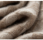 Close-up of a soft beige fabric showing the texture of a luxury women's knit sweater