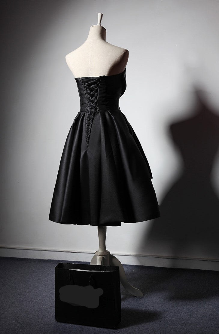 Back view of a Maison Noir Strapless Dress featuring a lace-up design and flared skirt