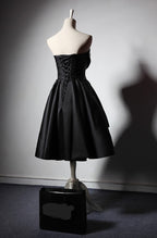 Back view of a Maison Noir Strapless Dress featuring a lace-up design and flared skirt