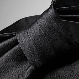 Close-up of the elegant detail on AM Vision RO Maison Noir Strapless Dress showcasing luxurious fabric texture