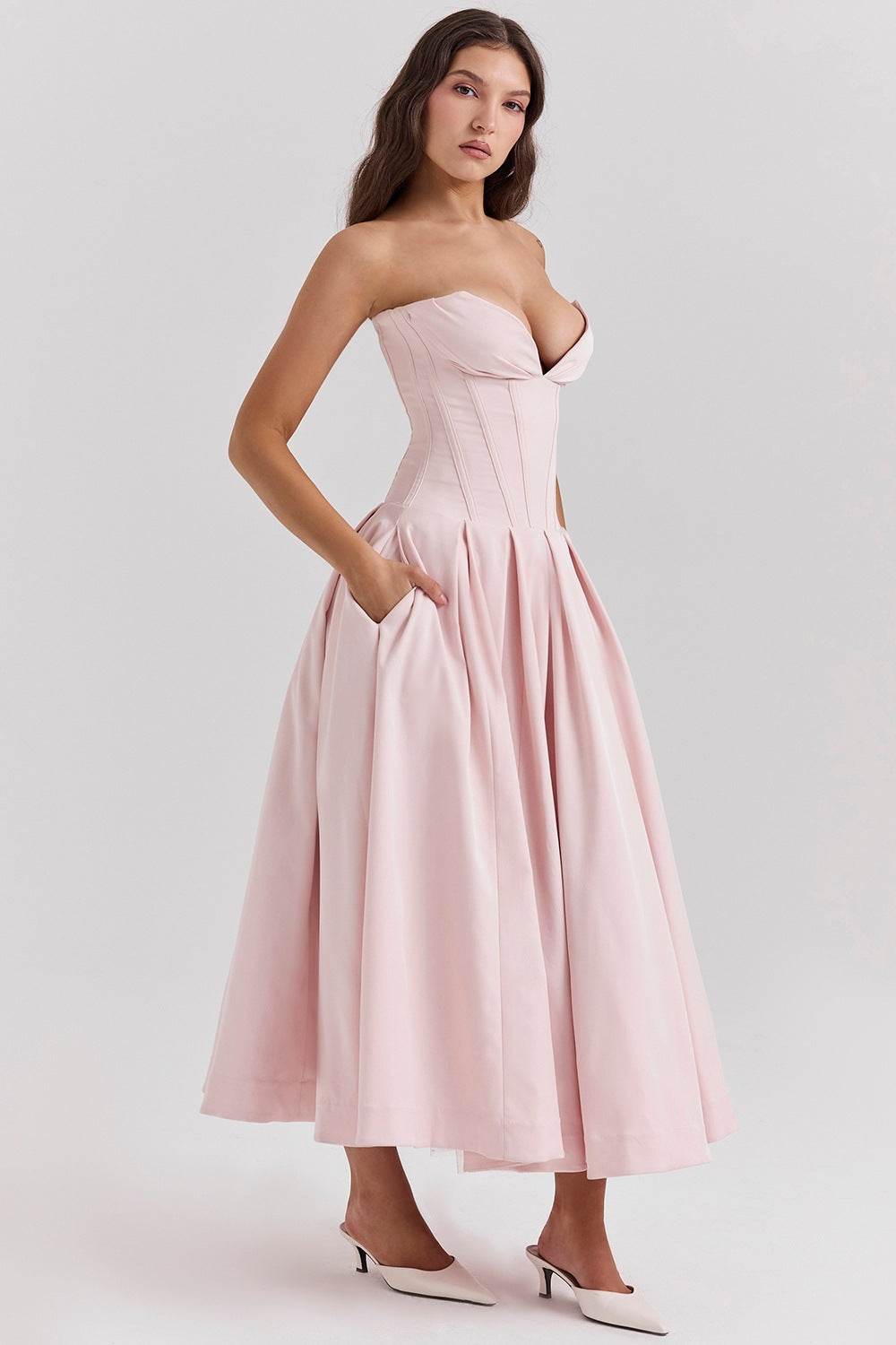 Elegant Pink Strapless Maxi Dress with Deep Neckline and Pockets for a Stylish Look