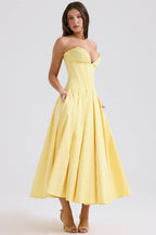 Elegant yellow maxi dress with deep neckline and strapless design, perfect for special occasions