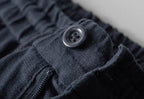 Close-up of AM Vision RO Men's Linen Pants with button detail and elastic waistband