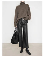 Stylish woman wearing Merard Luxe Sheepskin Pants paired with a cozy sweater and handbag