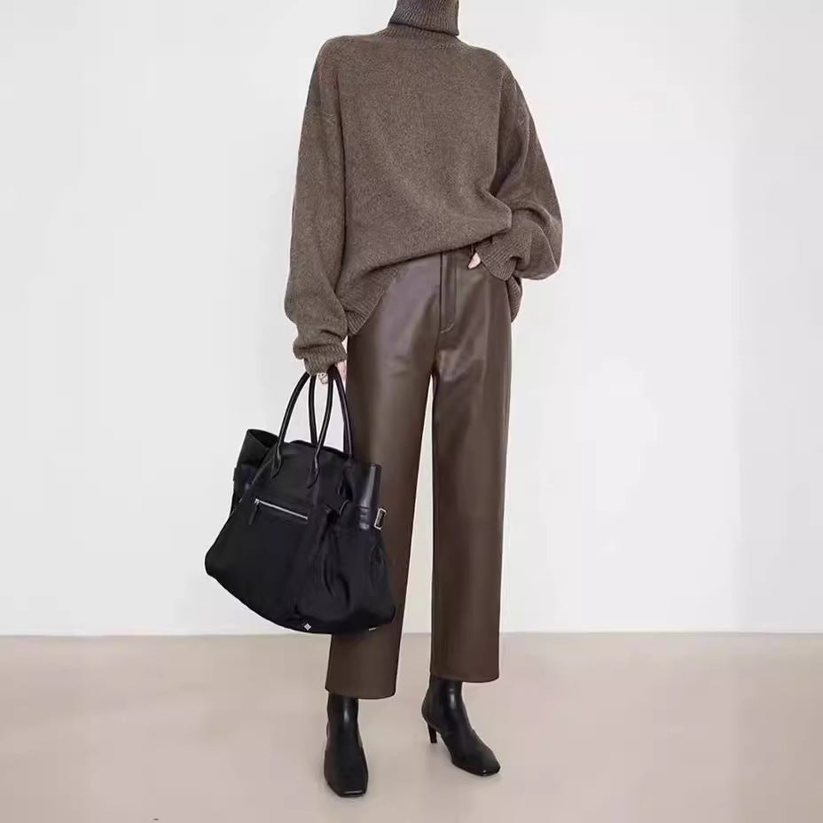Stylish model wearing Merard Luxe Sheepskin Pants paired with a cozy sweater and a chic handbag