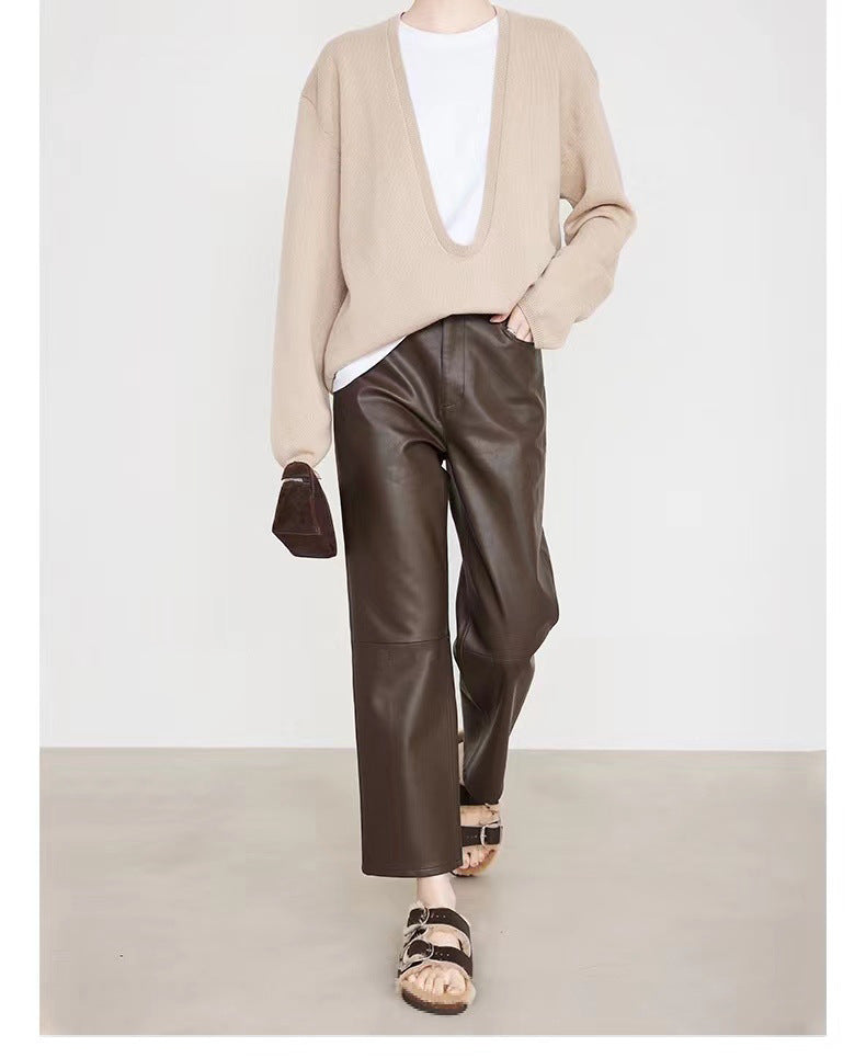 Stylish model wearing Merard Luxe Sheepskin Pants paired with a beige knit sweater and sandals