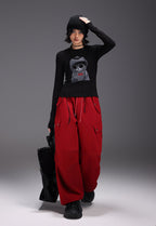 Stylish Midnight Cat Stretch Tee in Black featuring a cool cat graphic, paired with red cargo pants