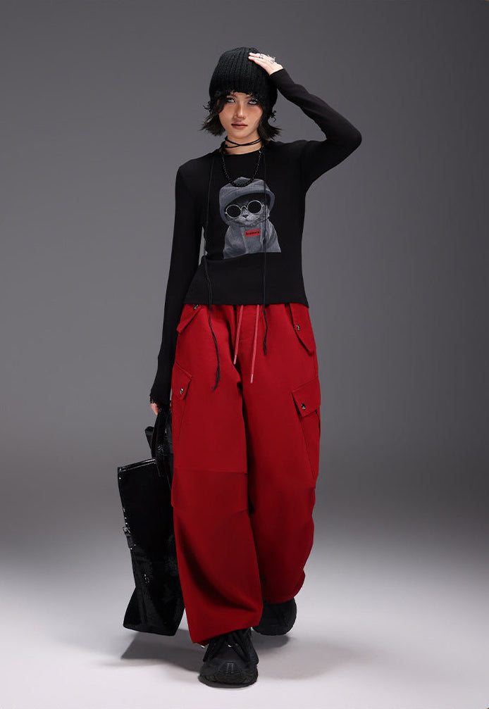 Stylish Midnight Cat Stretch Tee in Black featuring a cool cat graphic, paired with red cargo pants