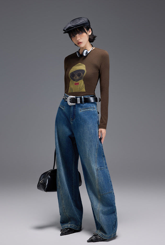 Stylish model wearing Midnight Cat Stretch Tee with graphic print and wide-leg denim pants