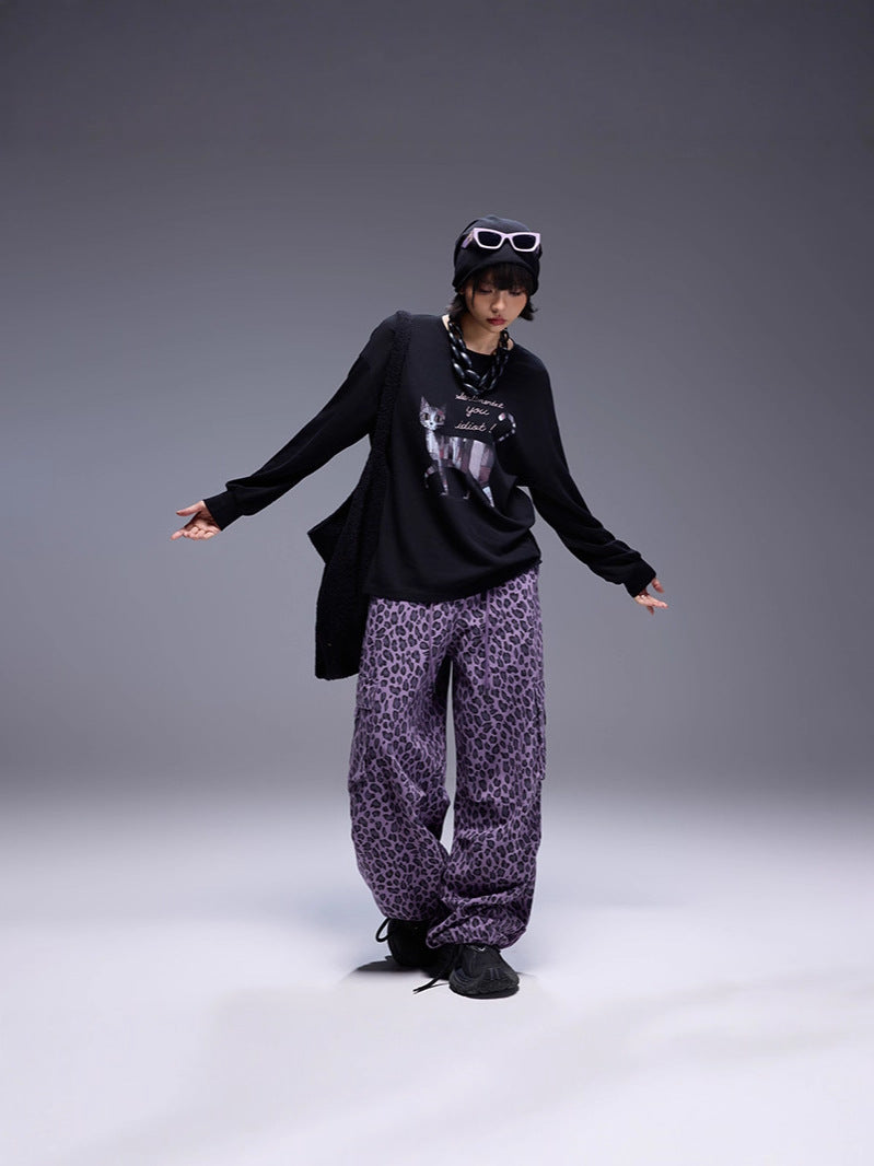 Model wearing Midnight Paws Street Top with stylish loose-fit leopard print pants and sunglasses