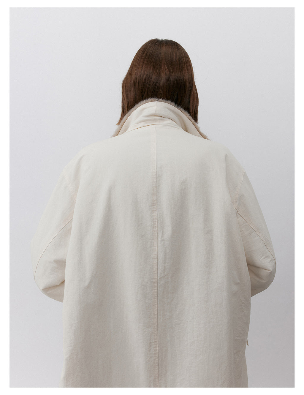 Back view of a Milk Tea Reversible Luxe Fur Trench showcasing its stylish and cozy design