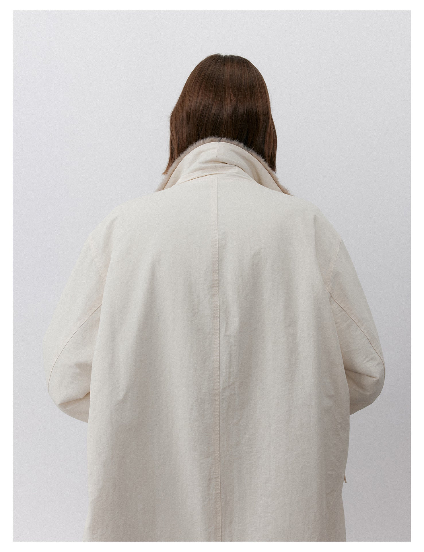 Back view of a Milk Tea Reversible Luxe Fur Trench showcasing its stylish and cozy design