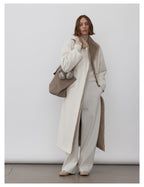 Model wearing a Milk Tea Reversible Luxe Fur Trench over white outfit, showcasing its stylish design