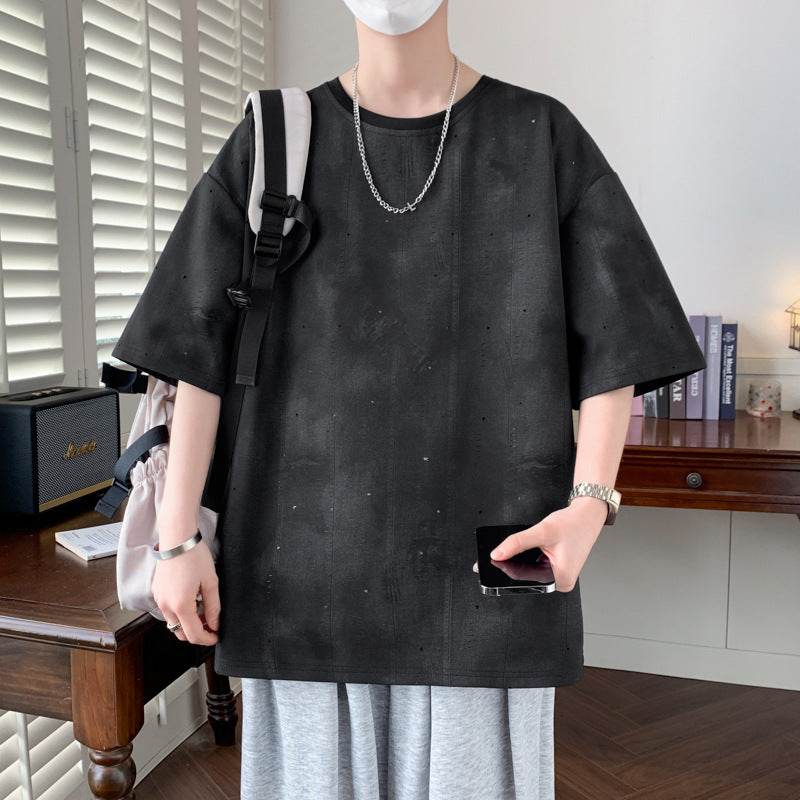 Casual black minimalist t-shirt for men with a loose fit, styled with gray shorts and accessories