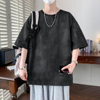 Casual black minimalist t-shirt for men with a loose fit, styled with gray shorts and accessories